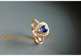 Blue Sapphire Teardrop Ring with Halo Diamonds - 18K White Gold