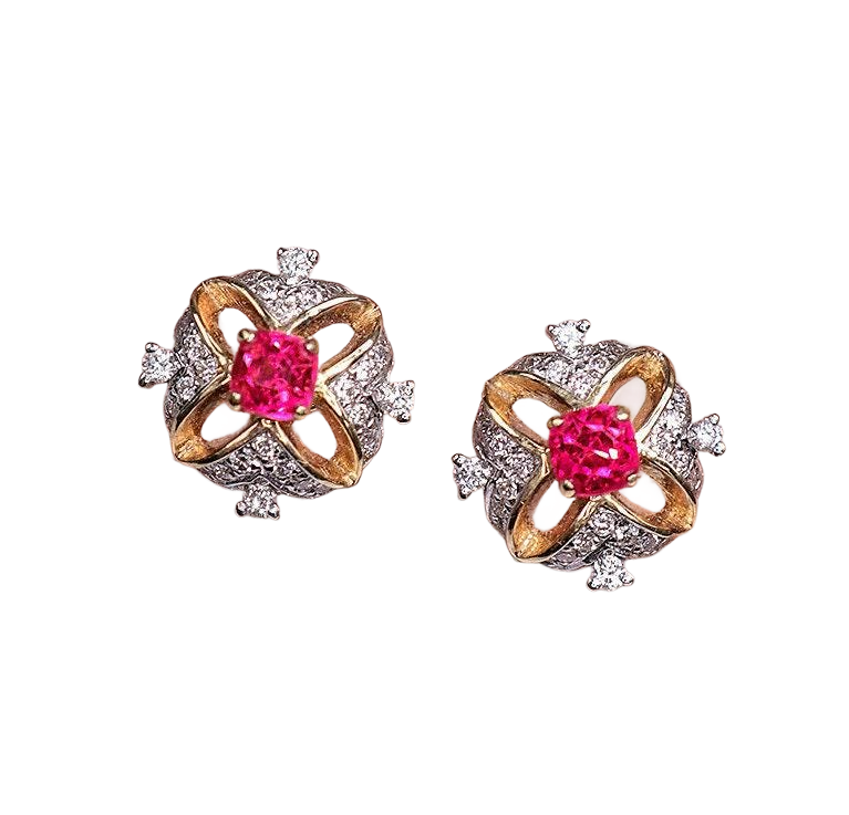 A pair of elegant earrings with a pink gemstone in the center, surrounded by a decorative design of diamonds and gold.